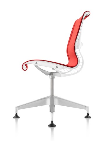 Profile view of a red Setu office chair.