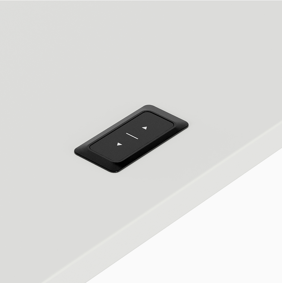 Detail of a black simple up/down switch on a height-adjustable table with a white surface and light grey leg.