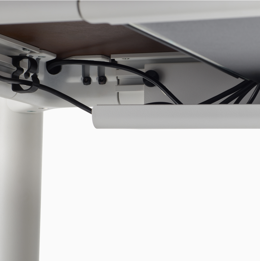 Undersurface of the four leg height-adjustable table showing cable tray and wire management.