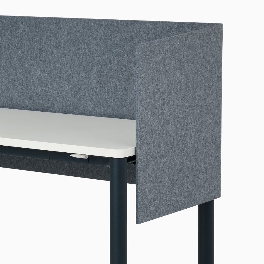 Front angle view of four leg height-adjustable table shown with grey screen, white surface, dark blue legs and casters.