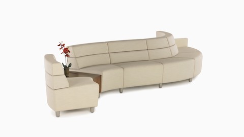 A curved configuration of beige, mid-back Steps Lounge System seating modules with an intervening surface.