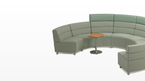 A semicircular Steps Lounge System configuration combining mid- and high-back seating modules in green upholstery. A semicircular Steps Lounge System configuration combining mid- and high-back seating modules in green upholstery.