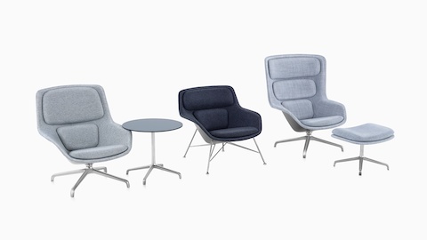 Low-back, mid-back, and high-back Striad lounge chairs upholstered in gray textiles line up, accompanied by a Striad Table and a Striad Ottoman.