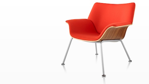 Swoop plywood lounge chair with red upholstery, viewed from a 45-degree angle. Swoop plywood lounge chair with red upholstery, viewed from a 45-degree angle.