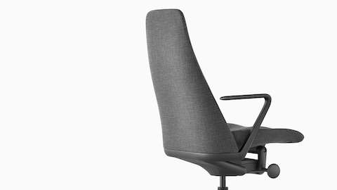 Three-quarter rear view of a Taper executive chair in gray fabric, showing contoured backrest. Three-quarter rear view of a Taper executive chair in gray fabric, showing contoured backrest.