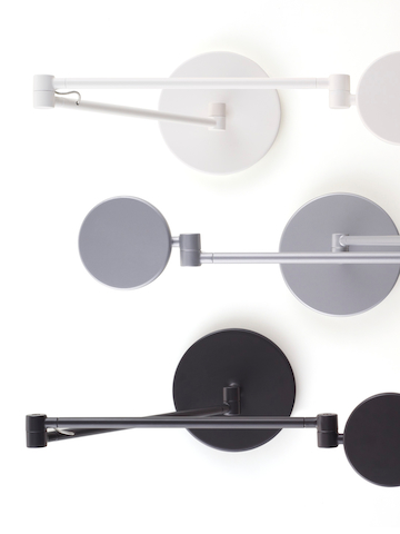 Overhead view of white, silver, and black Tone Personal Lights with articulating arms. Overhead view of white, silver, and black Tone Personal Lights with articulating arms.