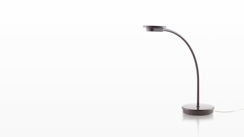 A black Tone Personal Light with a single curved arm.