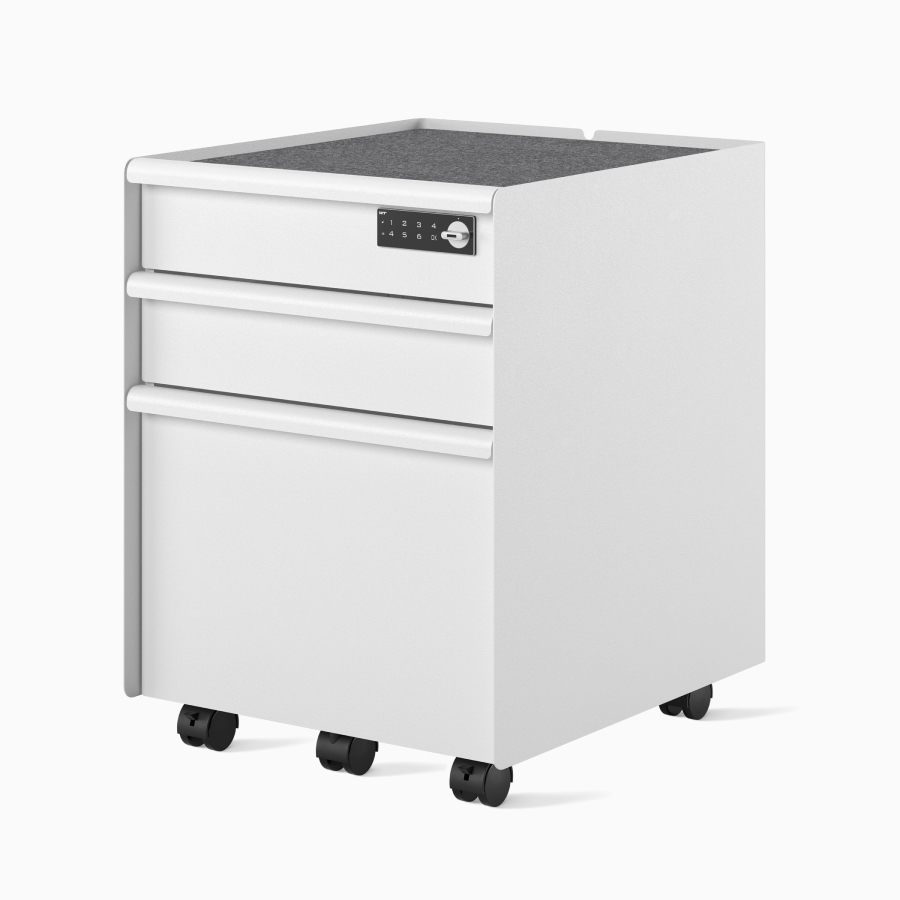 Front-angle view of a white Trac pedestal with a drawer/drawer/file configuration, PET liner, casters, digital lock, and metal drawer pulls.