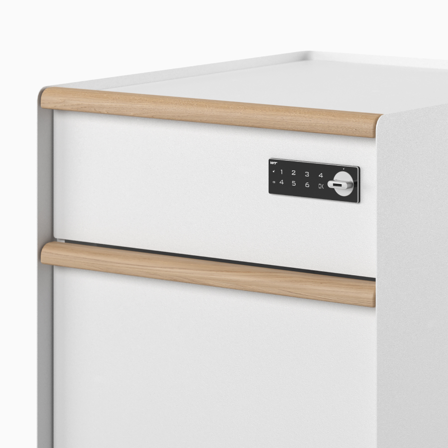 Close-up view of digital lock and wooden drawer pulls on a Trac pedestal.