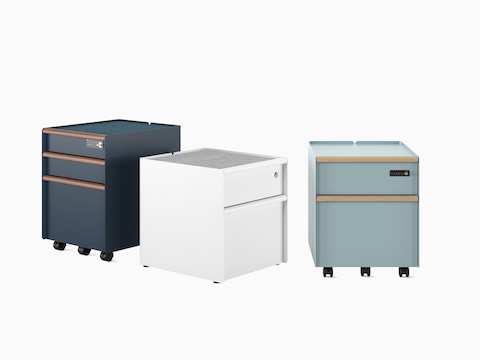 Group of Trac pedestals showing drawer/drawer/file in Nightfall with PET liner and digital lock, white drawer/ file on glides with basic lock, and drawer/file with wooden drawer pulls in Glacier.