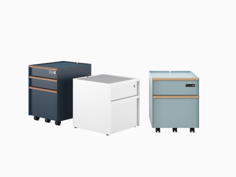 Group of Trac pedestals showing drawer/drawer/file in Nightfall with PET liner and digital lock, white drawer/file on glides with basic lock, and drawer/file with wooden drawer pulls in Glacier.