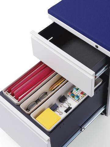 Overhead view of a Tu pedestal with drawers open to reveal interior storage trays. Overhead view of a Tu pedestal with drawers open to reveal interior storage trays.