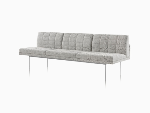 A Tuxedo Component Sofa with no arms, a metal base and quilted upholstery.