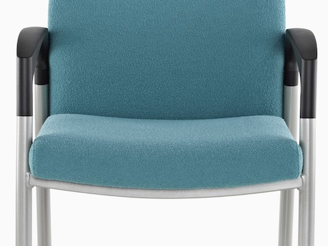 Close view of the memory foam seat and open arms on a blue Valor Multiple Seating chair.