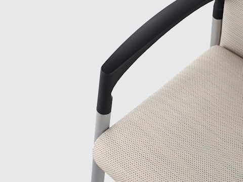 Close view of the open arm design on a beige Valor Patient Chair.