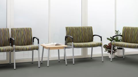 A healthcare waiting area featuring wide Valor Plus Seating upholstered in earth tones.