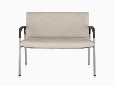 Beige Valor Plus Seating with an extra-wide seat, steel frame, and black arms, viewed from the front. Beige Valor Plus Seating with an extra-wide seat, steel frame, and black arms, viewed from the front.