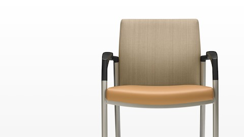 Close front view of a Valor Stack Chair with an orange seat and beige back.