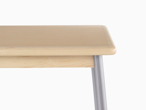 Close view of a steel leg and wood edge on a Valor Table.
