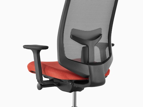 Rear view of a black Verus office chair with a red upholstered seat, showing patented PostureFit back support.