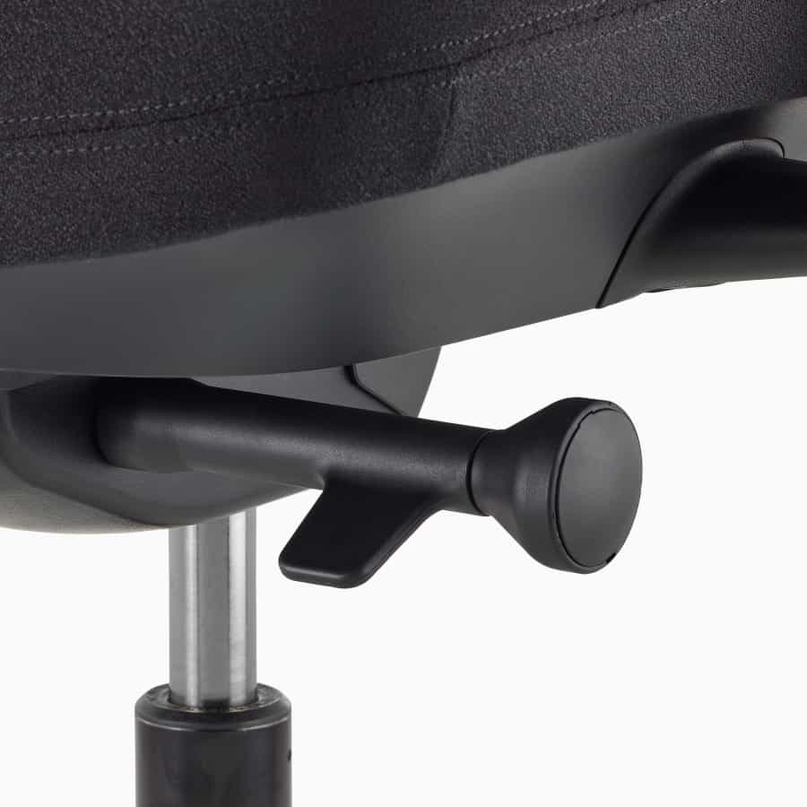 A close-up of a Verus Chair's forward seat angle adjustment on a synchronous tilt.