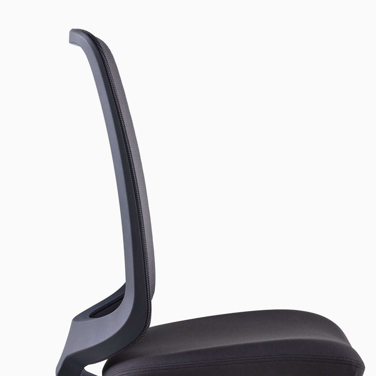 A close-up side view of a black Verus Chair. 