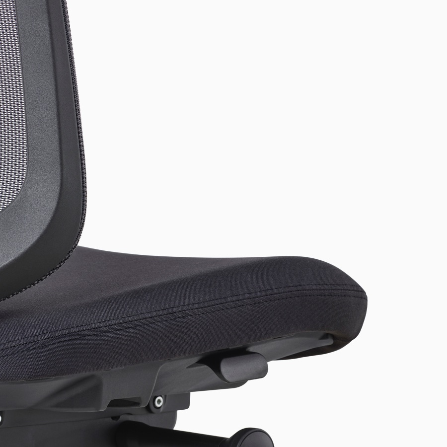 A close-up view of a black Verus Chair with no arms.