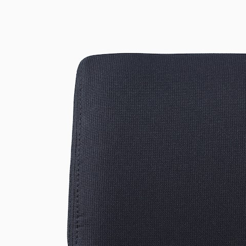 A close-up view of a black Verus Plus Chair upholstered back.