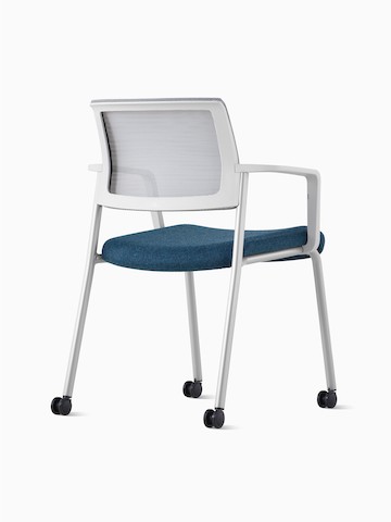 Back side view of a Verus Side Chair upholstered in blue with white suspension back and arms.