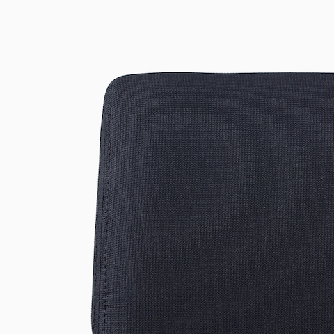 A close-up view of a Verus Side Chair's black upholstered back.