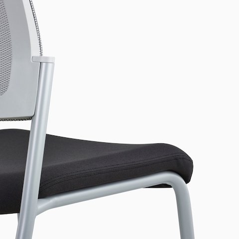 A close-up view of a gray Verus Side Chair's black upholstered seat with no arms.