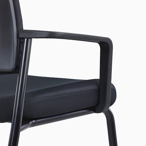 A close-up view of a dark blue Verus Side Chair's upholstered seat with fixed arms.