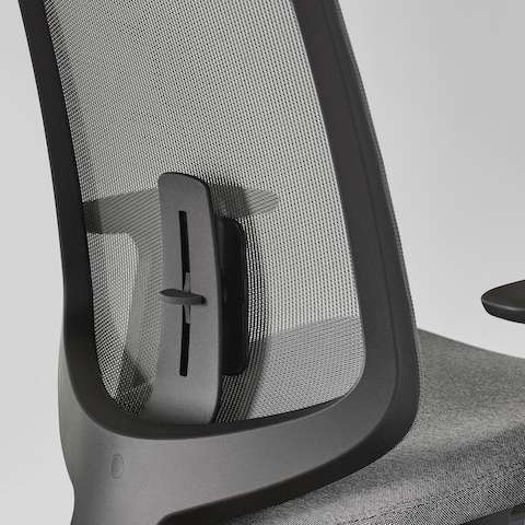 A close-up view of a Verus Stool with a black suspension back and adjustable lumbar support.