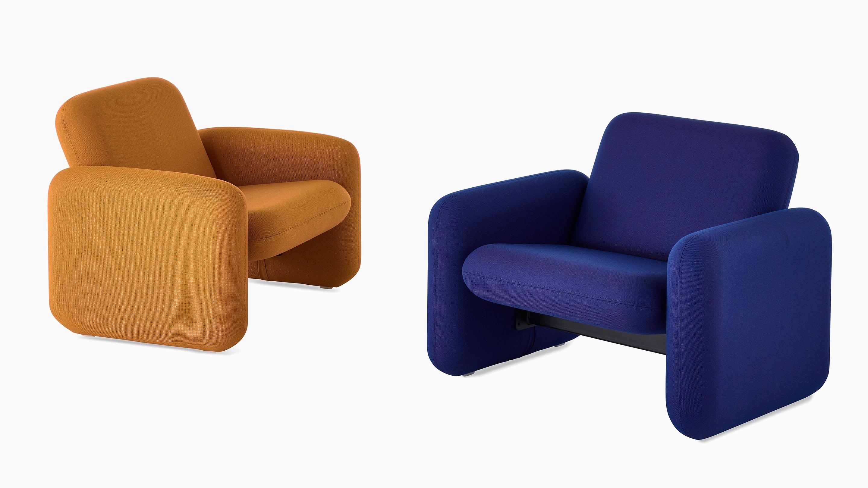Two Wilkes Modular Sofa Group Chairs facing each other at an angle. The chair on the left is dark yellow and the chair on the right is blue.