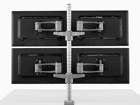 Rear view of four monitors attached to a single Wishbone Monitor Arm post.