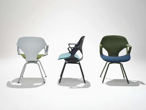 Three Zeph Side Chairs with fixed arms in various angles included an olive chair with blue seat pad, dark navy chair with a light blue seat pad and an alpine chair with an olive seat cover.
