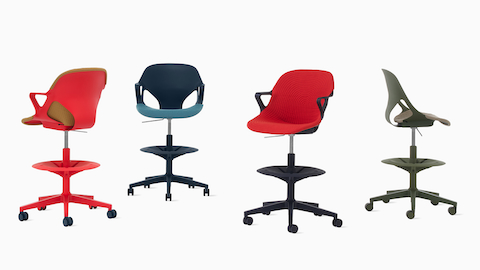 Four Zeph Stools in various angles including a red stool with brown knit cover, a dark blue stool with a light blue knit seat pad, a black stool with a red seat cover and a olive stool with a light pink seat pad.