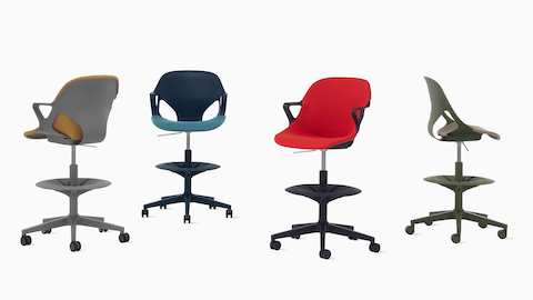 Four Zeph Stools in various angles including a cocoa stool with brown knit cover, a dark blue stool with a light blue knit seat pad, a black stool with a red seat cover and a olive stool with a light pink seat pad.