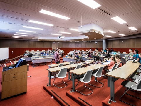 Students listen to an instructor during a classroom session.