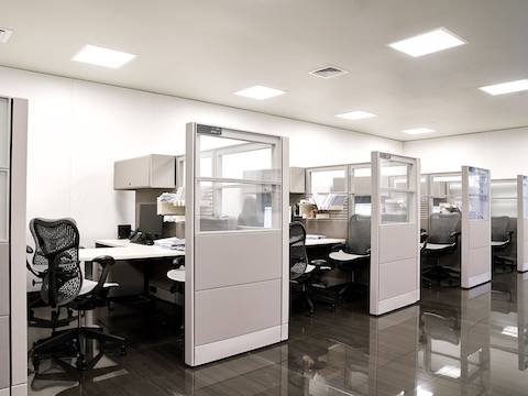 A row of five consultation cubicles of Ethospace system, cubicle on the left showing grey Mirra 2 chair shown from the back.