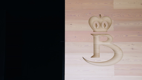 The company's logo carved on wood at the entrance to the main offices. The company's logo carved on wood at the entrance to the main offices.