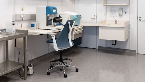 Co/Struc Wall mounted workstation, wire chase rail with cover and Sayl stool chair on caster with Vinyl upholstery.