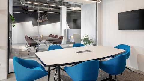 Six Always Chairs in blue fabric around a meeting table.