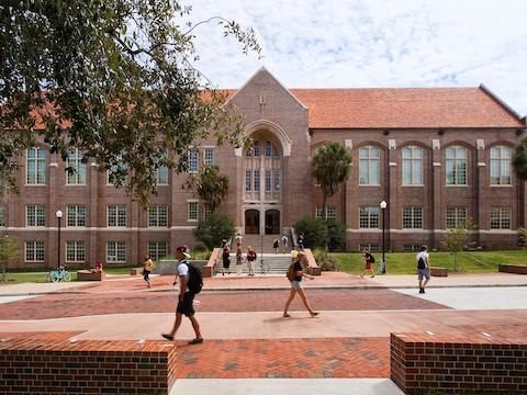 University students walk by the front entrance of the William Johnston Building. 