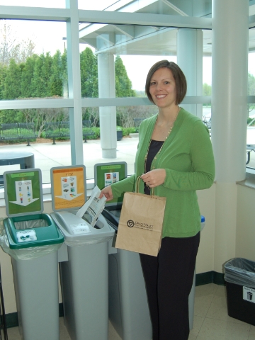 A Grand Valley State faculty member sorts her recyclables into the appropriate bins. 