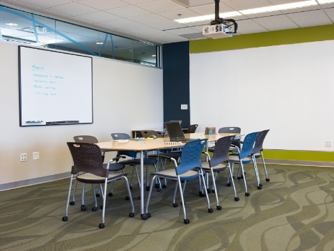 A meeting room within the Greenhouse, outfitted with Caper chairs and an Intersect table.