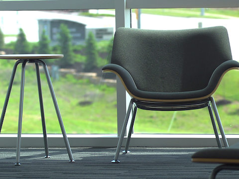 Swoop lounge furnishings sit in front of a large window. Swoop lounge furnishings sit in front of a large window.
