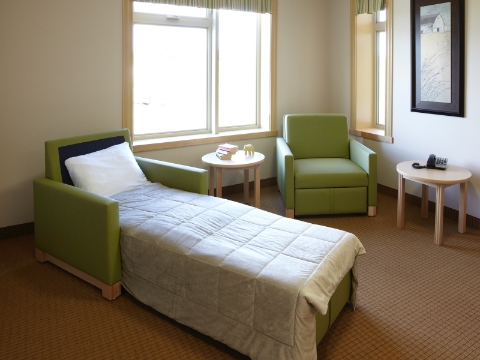 A Beaumont sleep chair sits unfolded next to another still in a sitting position. A Beaumont sleep chair sits unfolded next to another still in a sitting position.
