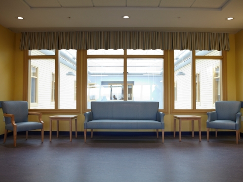 Lounge seating sits in an open area near a window, overlooking a courtyard. Lounge seating sits in an open area near a window, overlooking a courtyard.