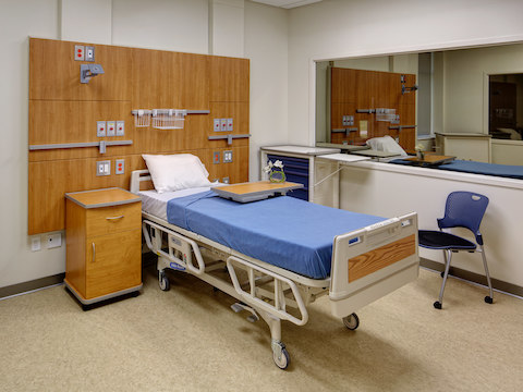 Two mock patient rooms set up within a classroom environment. 